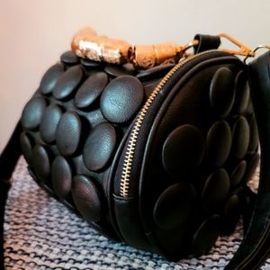 Barrel-Shaped Faux Black Leather Shoulder Bag with Skull Details